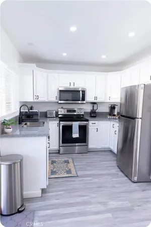 a kitchen with wooden cabinets and stainless steel appliances