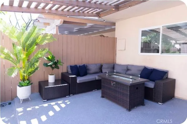 a living room with furniture potted plant and a window