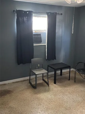 a view of a livingroom with furniture and windows