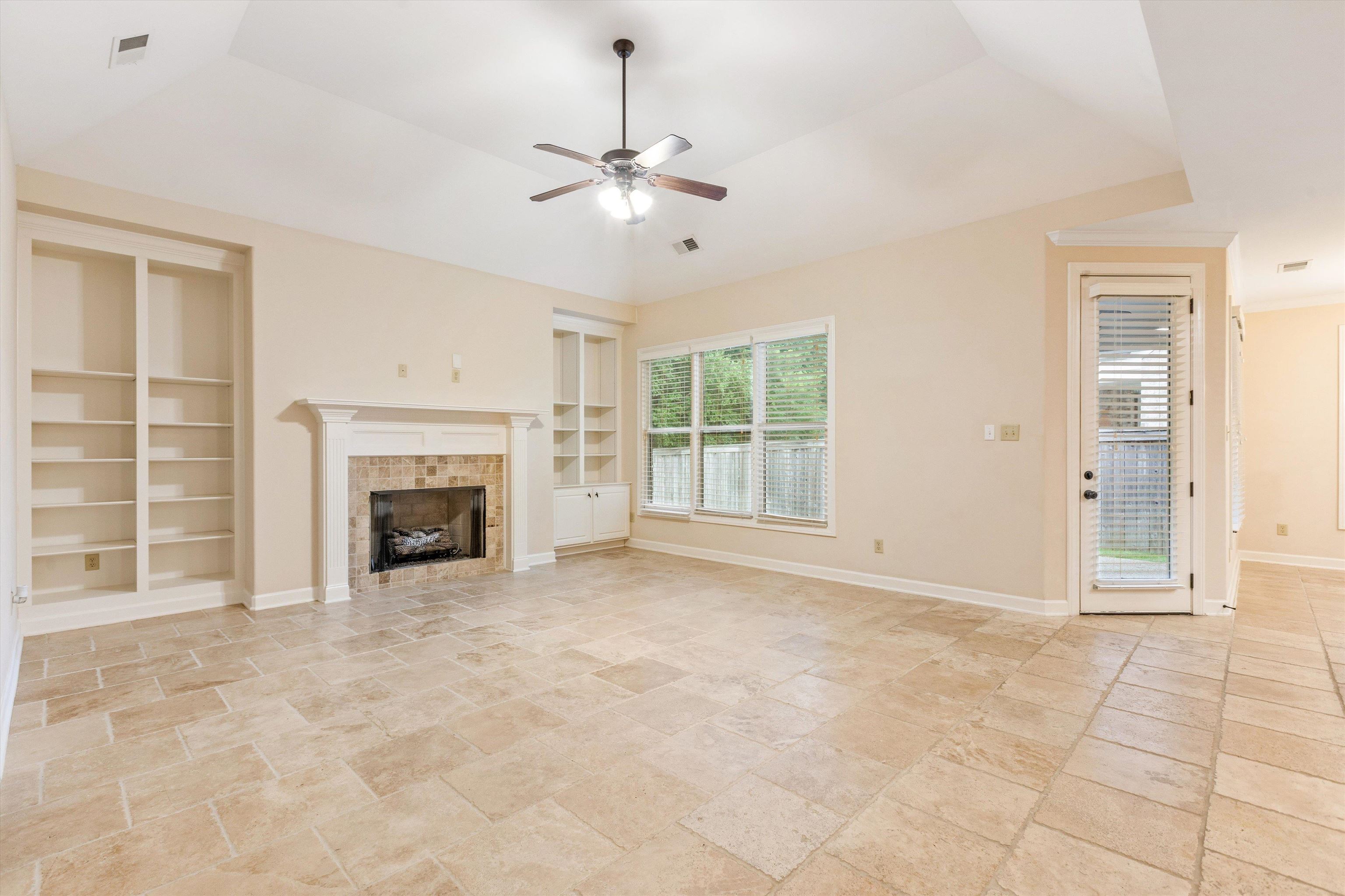 1651 Dehaig Lane Collierville, TN 38017 - Photo 11 of 36 a view of an empty room with a fireplace and a window