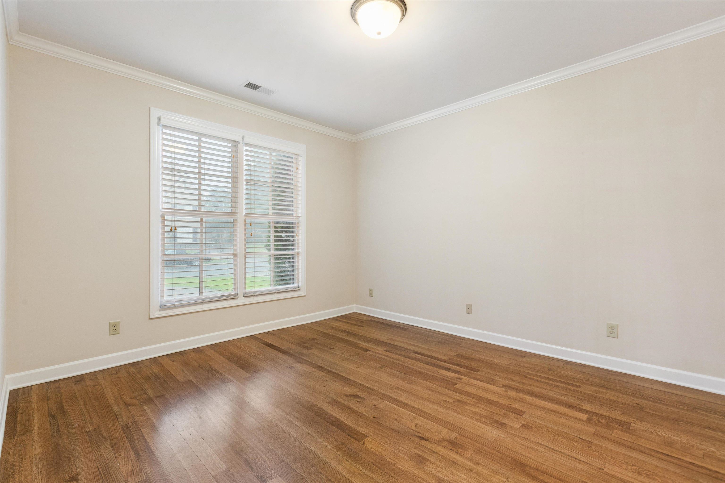 1651 Dehaig Lane Collierville, TN 38017 - Photo 18 of 36 wooden floor in an empty room with a window
