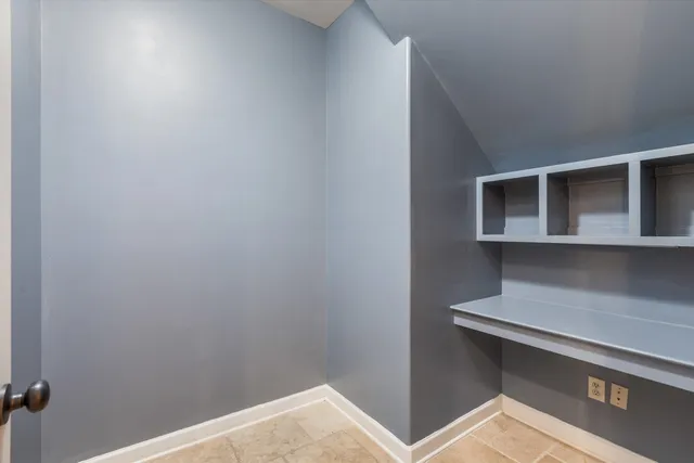 an empty room with closet area and mirrors