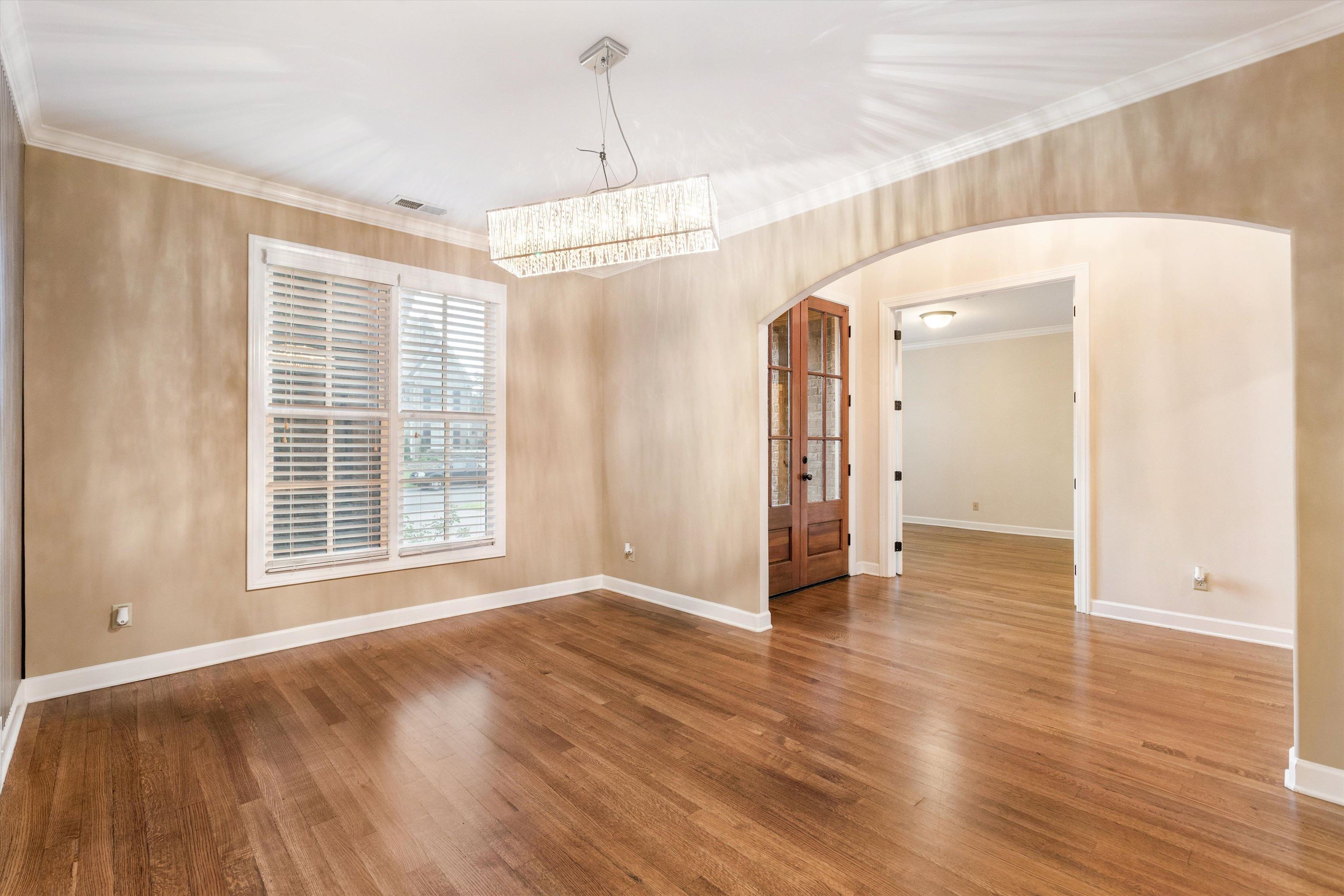 1651 Dehaig Lane Collierville, TN 38017 - Photo 4 of 36 a view of an empty room with wooden floor and a window