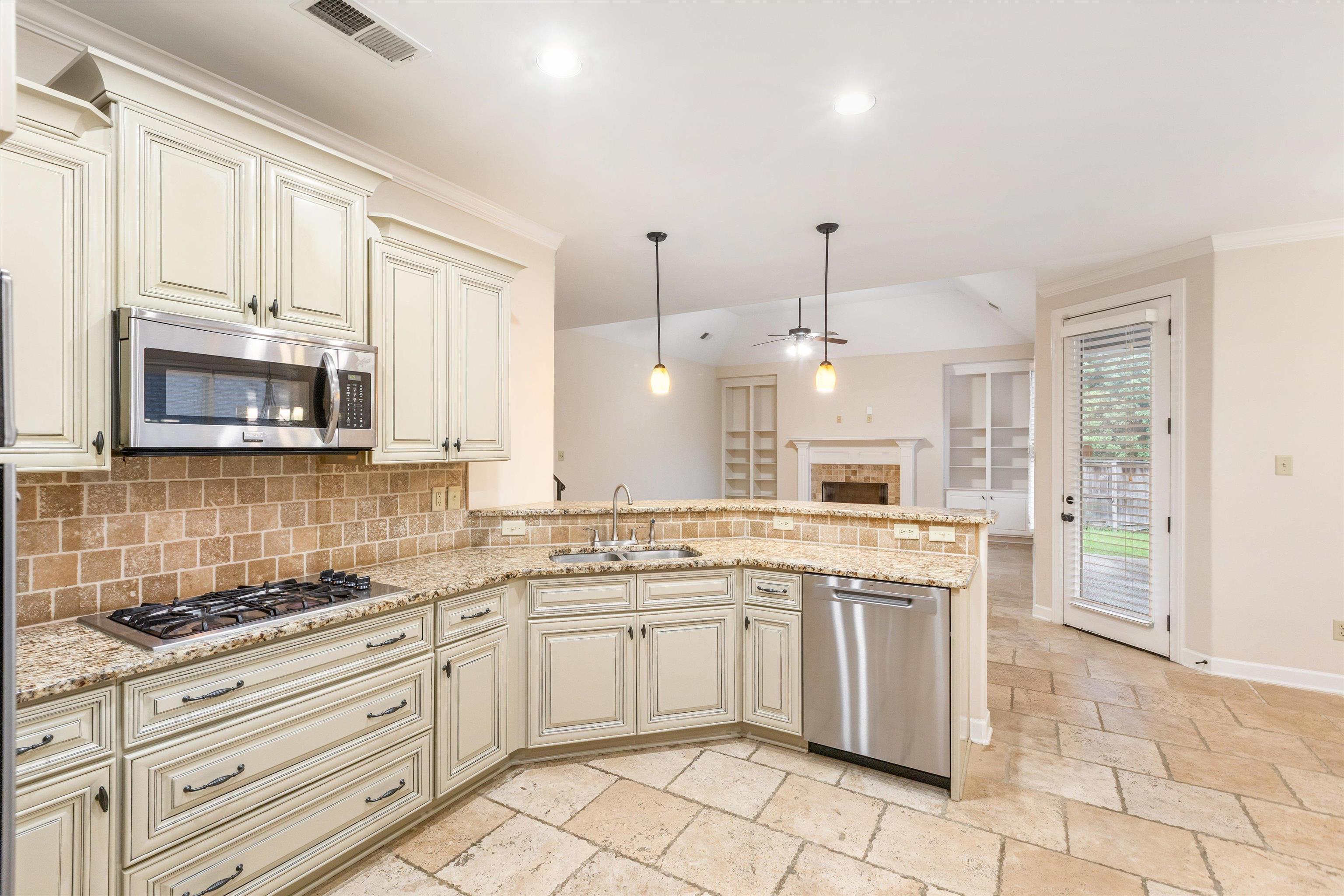 1651 Dehaig Lane Collierville, TN 38017 - Photo 7 of 36 a kitchen with white cabinets appliances and a sink