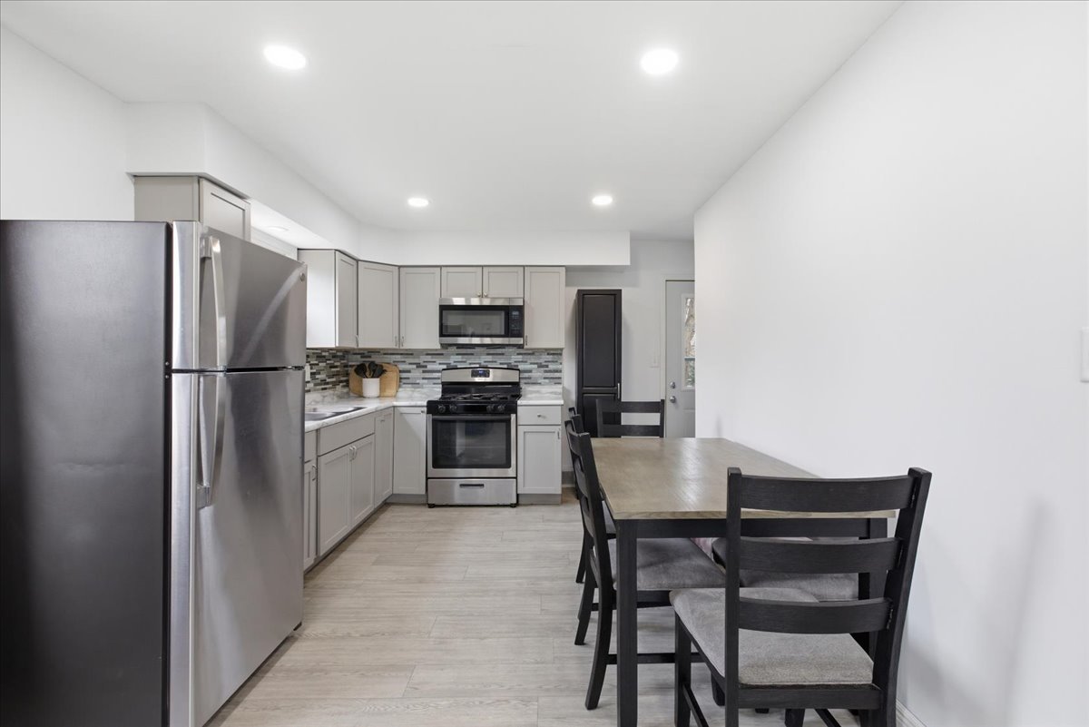 270 Ridge Avenue Crystal Lake, IL 60014 - Photo 5 of 19 a kitchen with stainless steel appliances a refrigerator stove microwave and cabinets