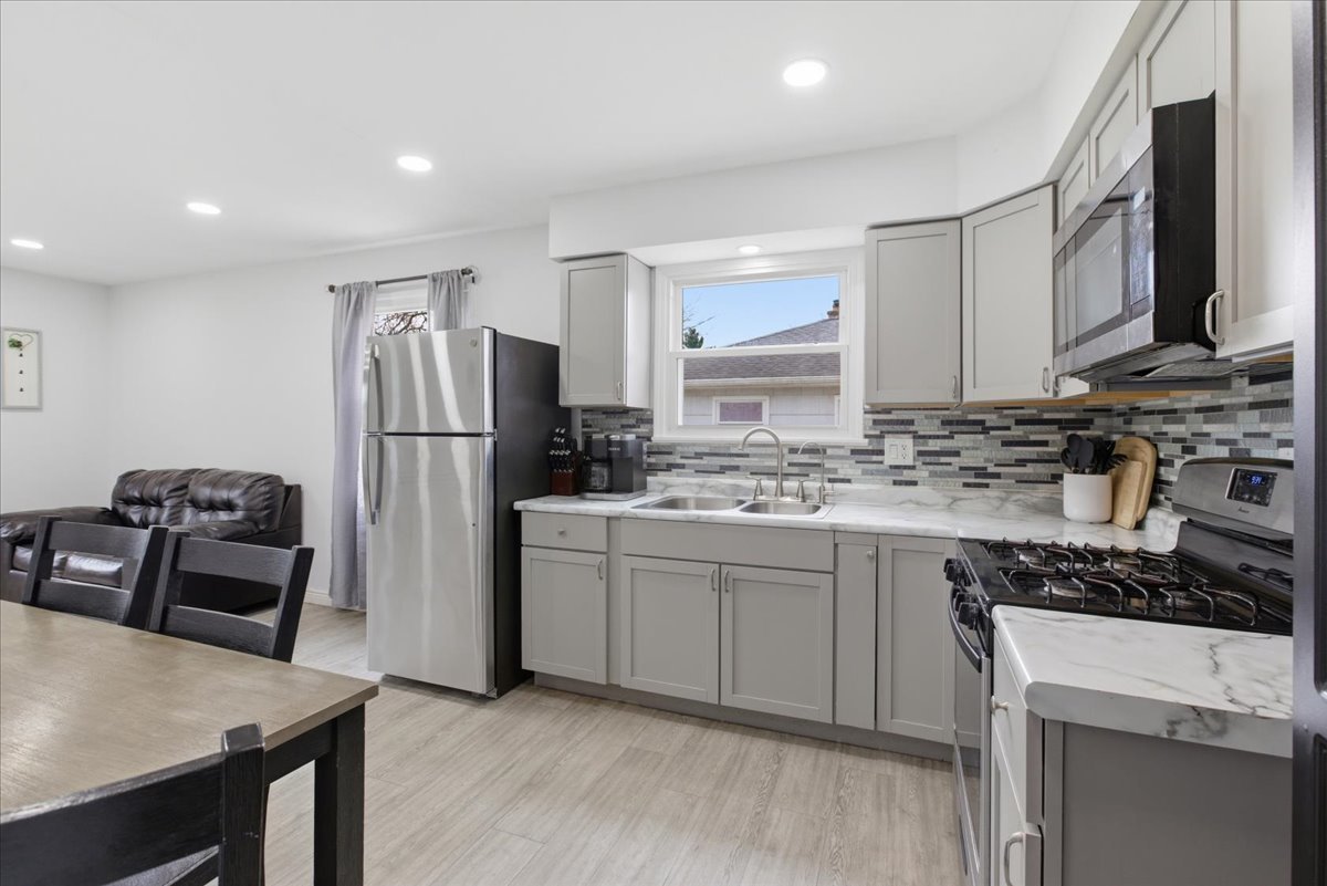 270 Ridge Avenue Crystal Lake, IL 60014 - Photo 6 of 19 a kitchen with refrigerator cabinets and wooden floor