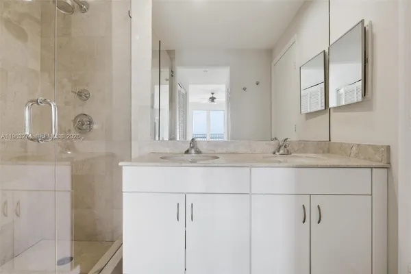 a bathroom with a double vanity sink and mirror