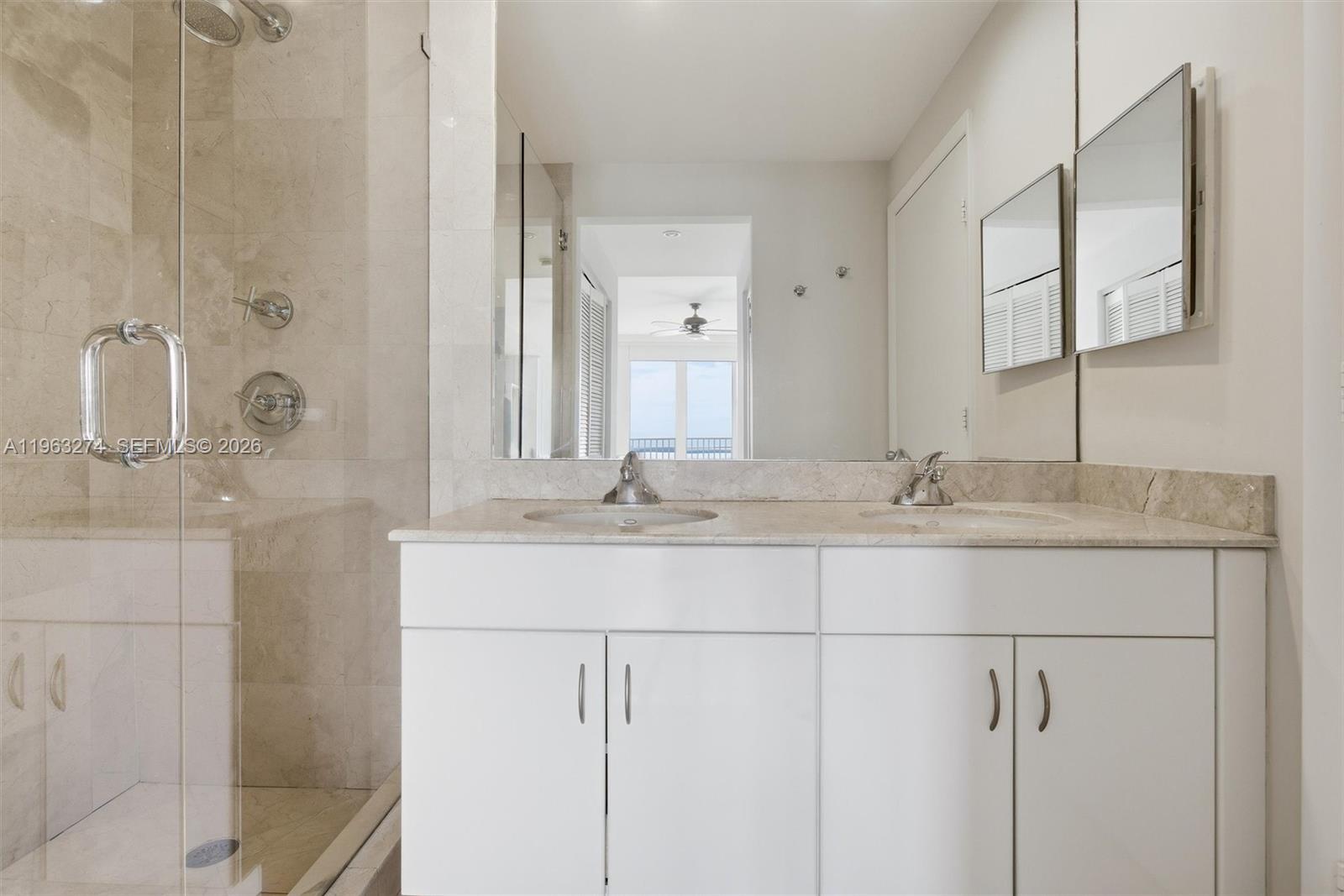 801 Brickell Key Boulevard, Unit 3209 Miami, FL 33131 - Photo 11 of 24 a bathroom with a double vanity sink and mirror
