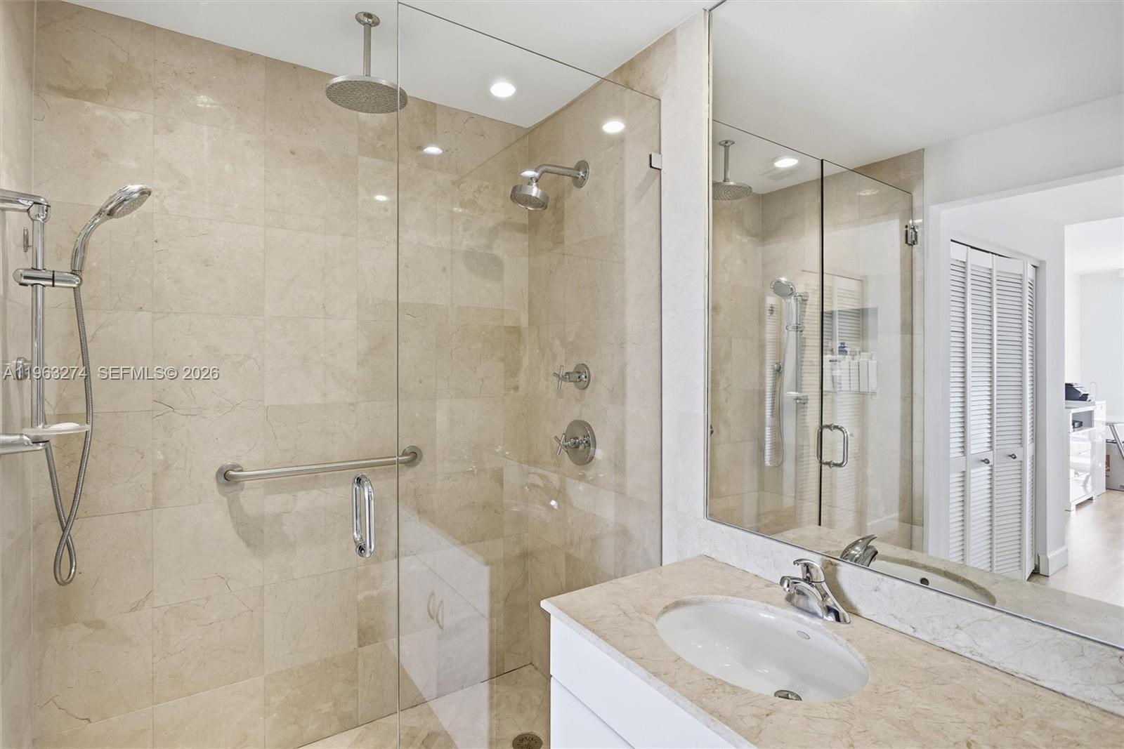 801 Brickell Key Boulevard, Unit 3209 Miami, FL 33131 - Photo 12 of 24 a bathroom with a granite countertop shower sink and mirror
