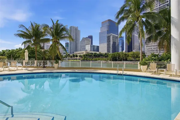a view of swimming pool with palm trees