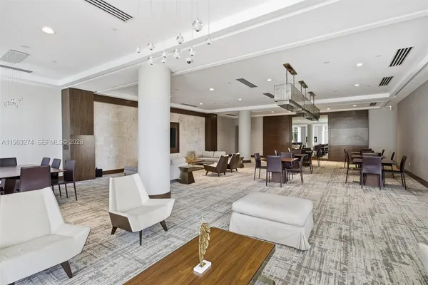 a living room with furniture and view of kitchen