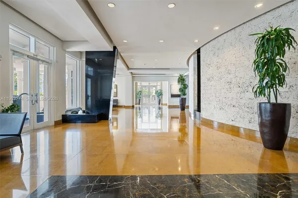 a lobby with furniture and floor to ceiling window