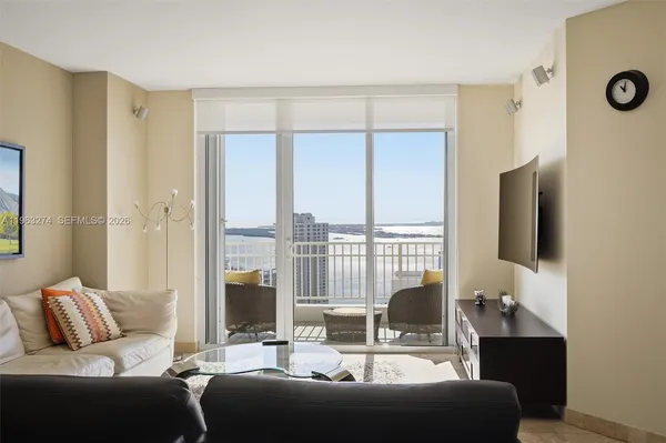 a living room with furniture and a flat screen tv