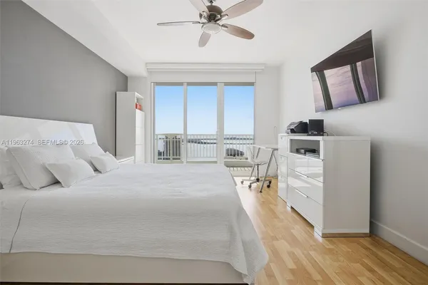 a bed room with a bed and a chandelier