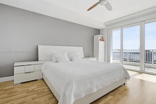 a bedroom with a large bed and a large window
