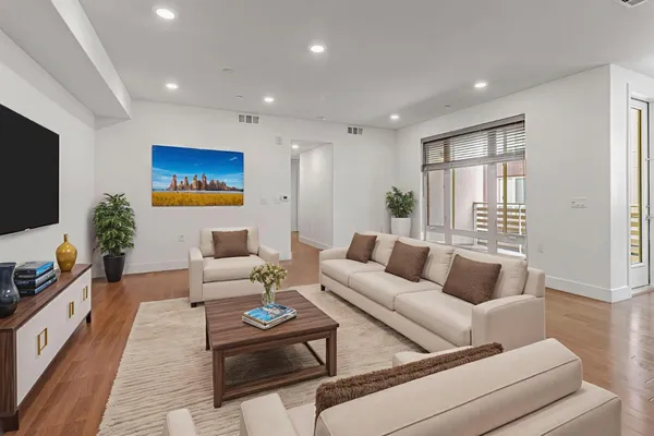 a kitchen with stainless steel appliances granite countertop a sink a stove a refrigerator cabinets and chairs