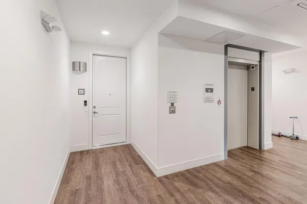 a view of a hallway with wooden floor