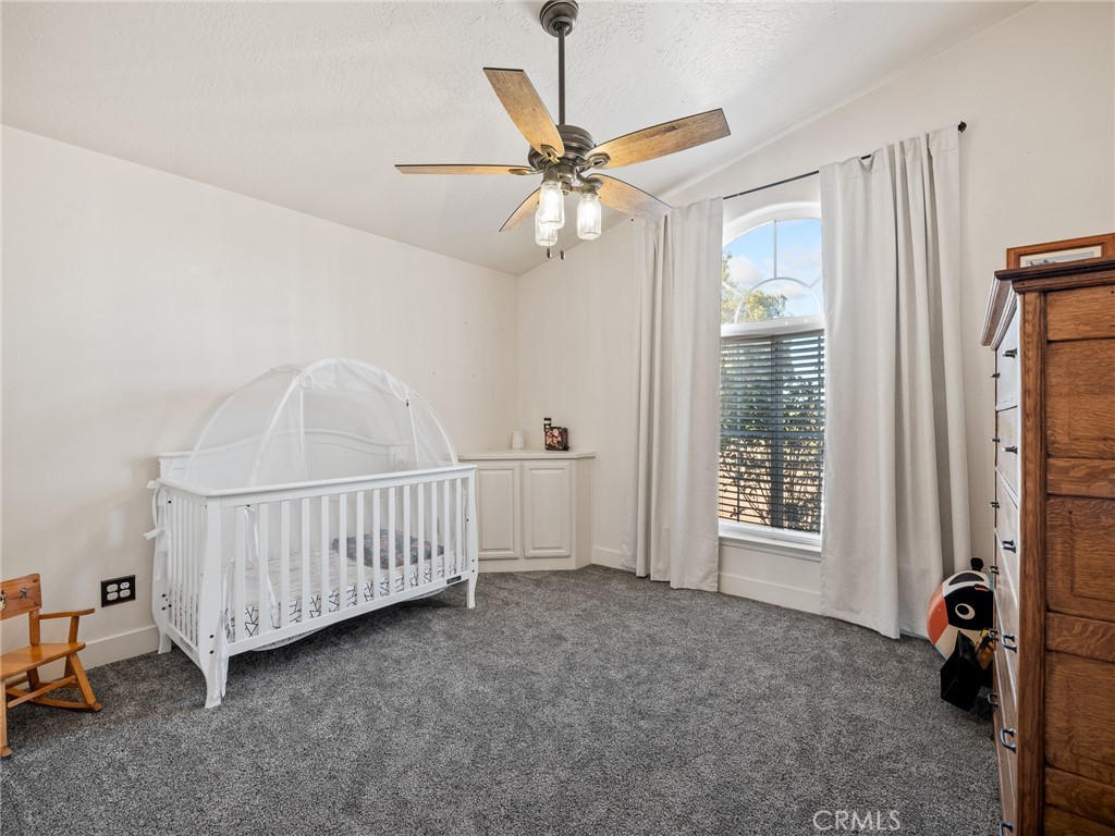 6370 Fremontia Road Hesperia, CA 92344 - Photo 16 of 62 a view of an empty room with chandelier fan and a window