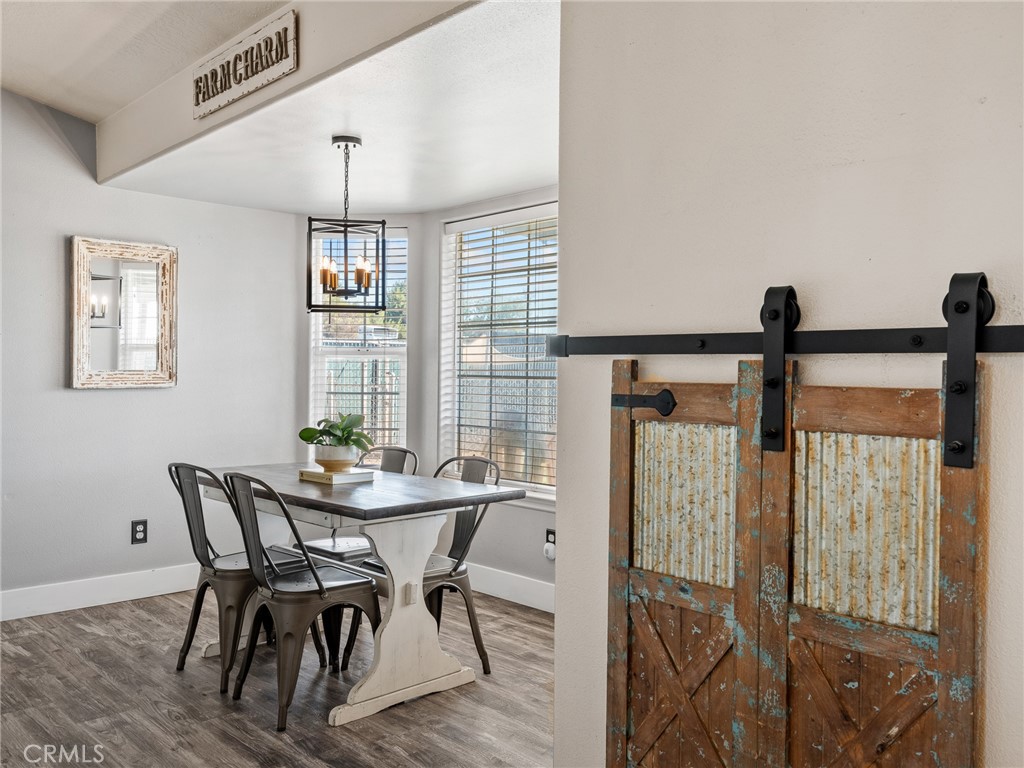6370 Fremontia Road Hesperia, CA 92344 - Photo 23 of 62 a view of a dining room with furniture window and wooden floor