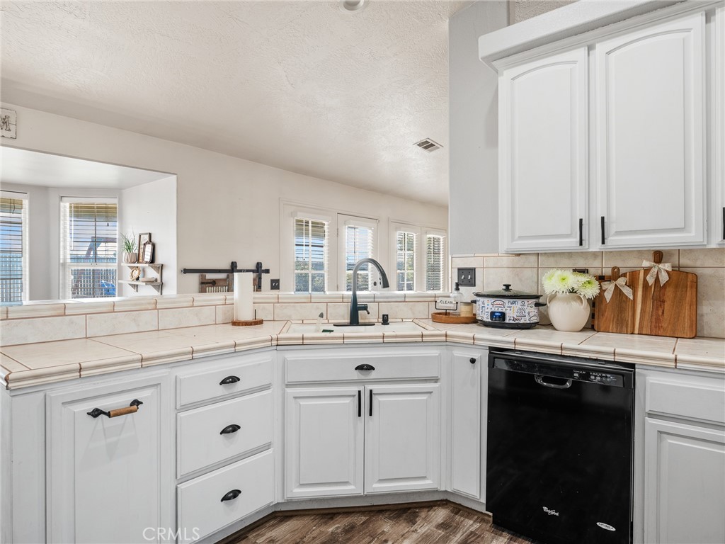 6370 Fremontia Road Hesperia, CA 92344 - Photo 28 of 62 a kitchen with white cabinets and sink