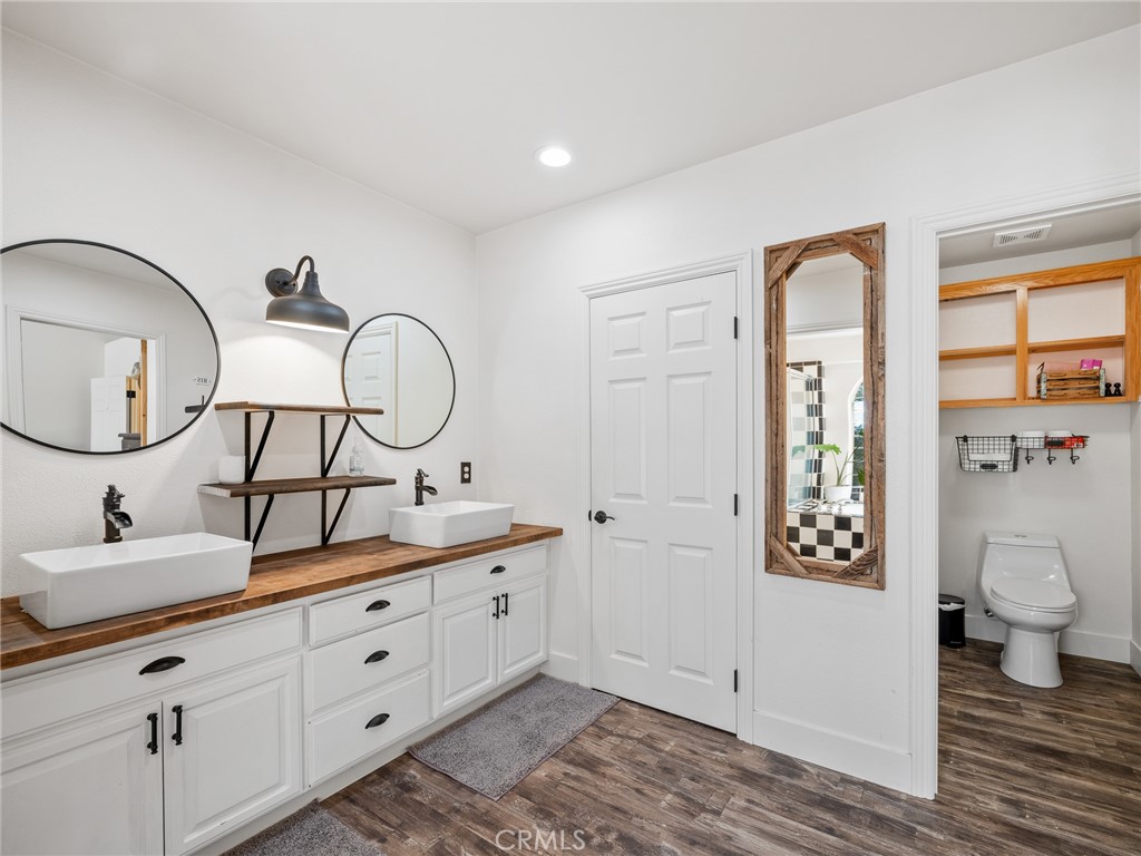 6370 Fremontia Road Hesperia, CA 92344 - Photo 34 of 62 a bathroom with a toilet a sink and a mirror
