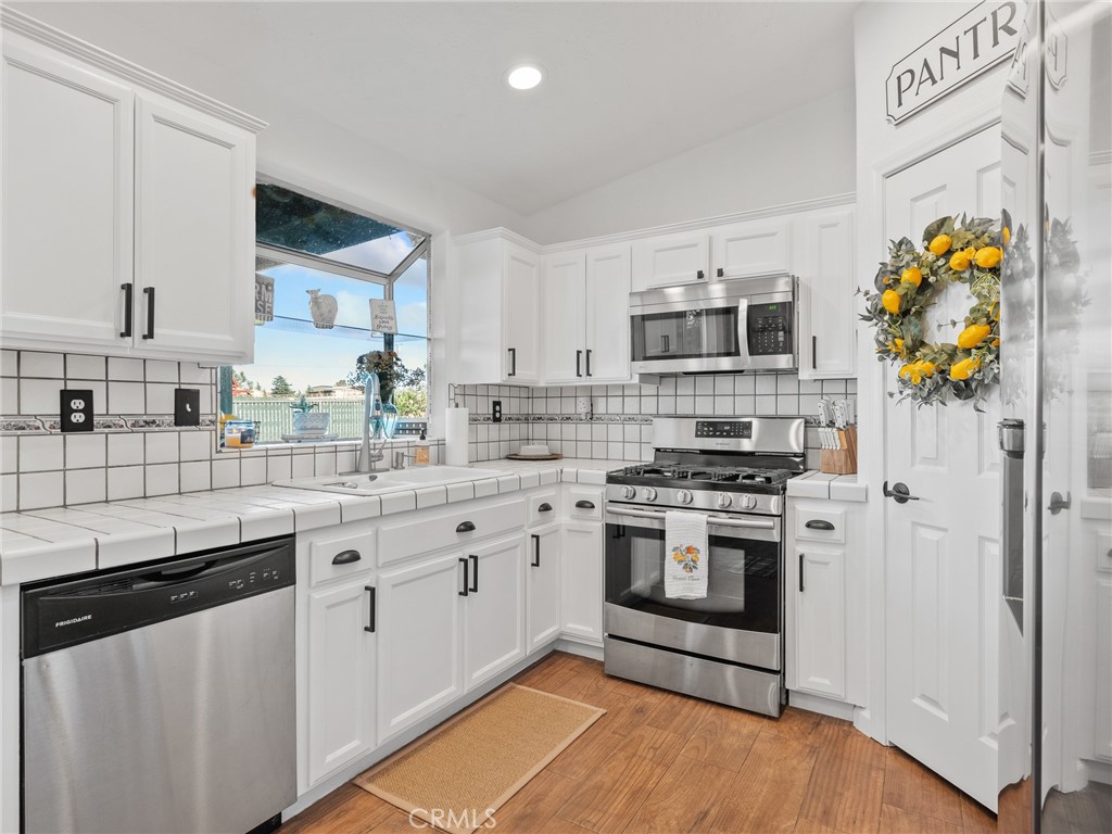 6370 Fremontia Road Hesperia, CA 92344 - Photo 56 of 62 a kitchen with stainless steel appliances granite countertop a stove and a sink