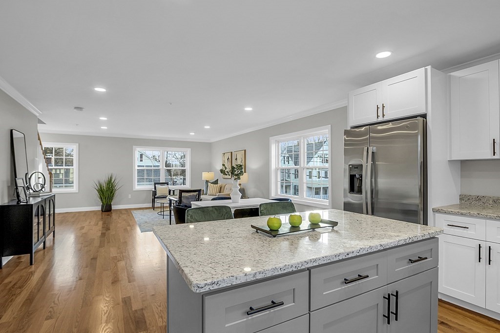 30 Broadway, Unit A Lynn, MA 01904 - Photo 12 of 34 a large kitchen with a large counter top appliances and cabinets