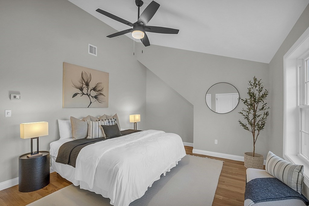 30 Broadway, Unit A Lynn, MA 01904 - Photo 22 of 34 a bedroom with bed and a chandelier