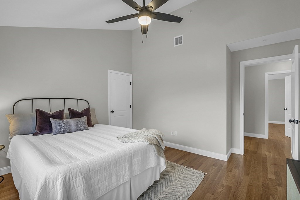 30 Broadway, Unit A Lynn, MA 01904 - Photo 26 of 34 a bedroom with a bed and wooden floor