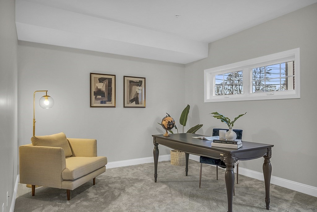 30 Broadway, Unit A Lynn, MA 01904 - Photo 33 of 34 a living room with furniture and a wall painting