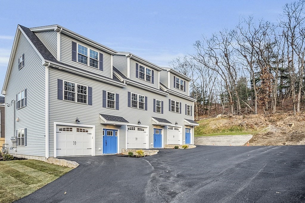 30 Broadway, Unit A Lynn, MA 01904 - Photo 5 of 34 a front view of residential houses with yard