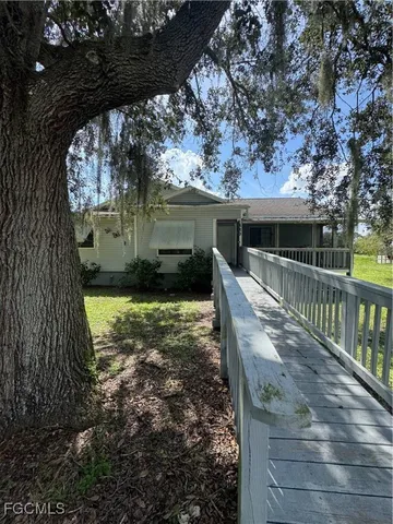 a view of a house with backyard and sitting area