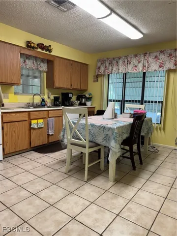 a kitchen with a sink and chairs