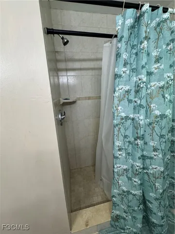 a bed sitting in a bedroom and dresser