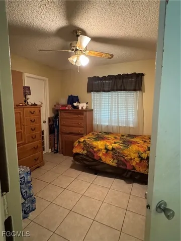 a bathroom with a granite countertop sink a toilet a mirror and shower