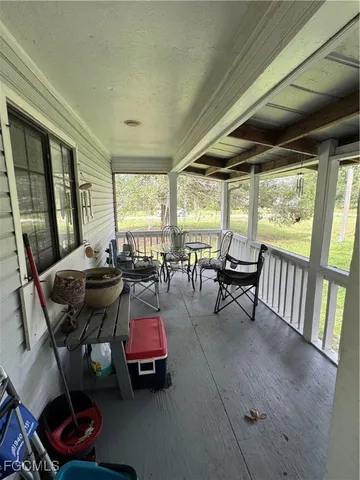 a view of a porch and wooden floor