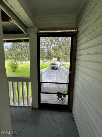 a view of a chair and table in the back yard