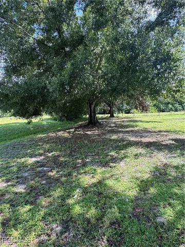 a view of yard with swimming pool and green space