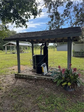 a view of a porch with furniture and a yard