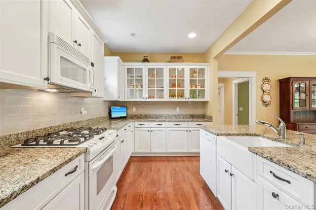 a kitchen with stainless steel appliances granite countertop a stove and a sink