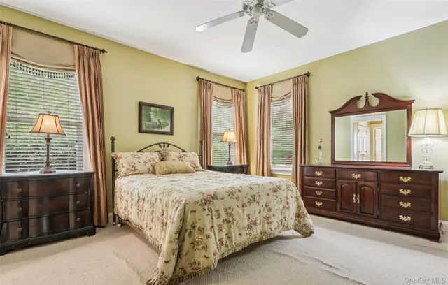 a bedroom with a large bed and a dresser