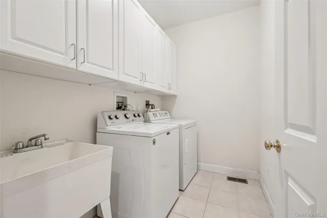 a utility room with sink dryer and washer