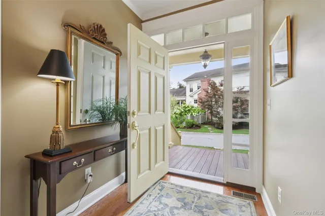 a view of a hallway with wooden floor and windows