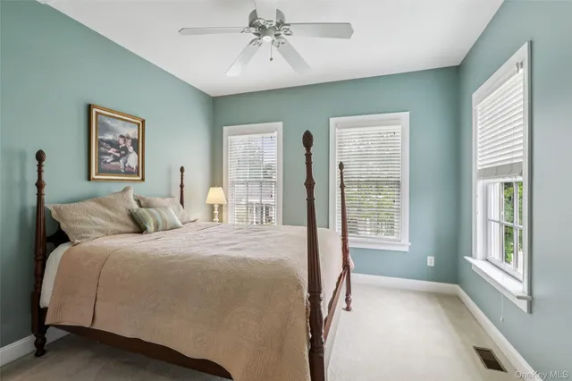 a bedroom with a large bed and a window