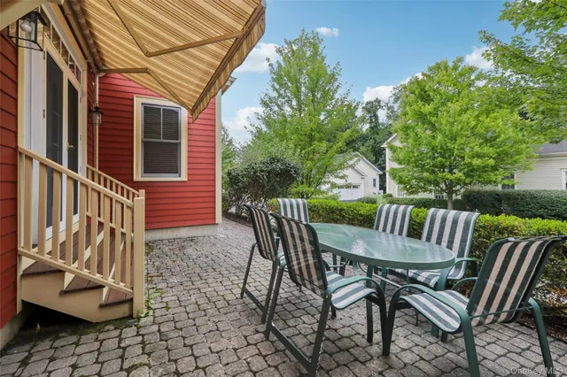 a view of a chairs and table in the balcony