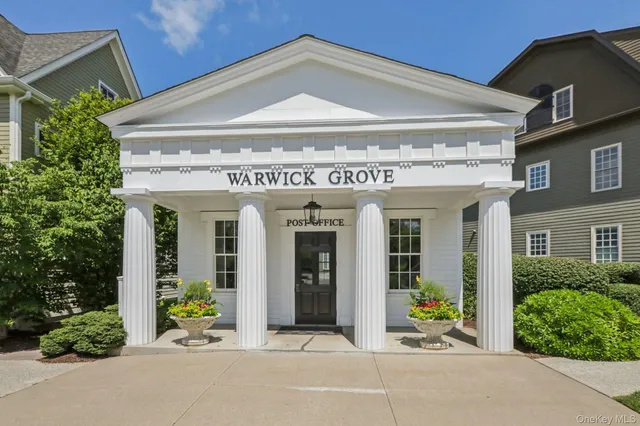 a view of a house with potted plants