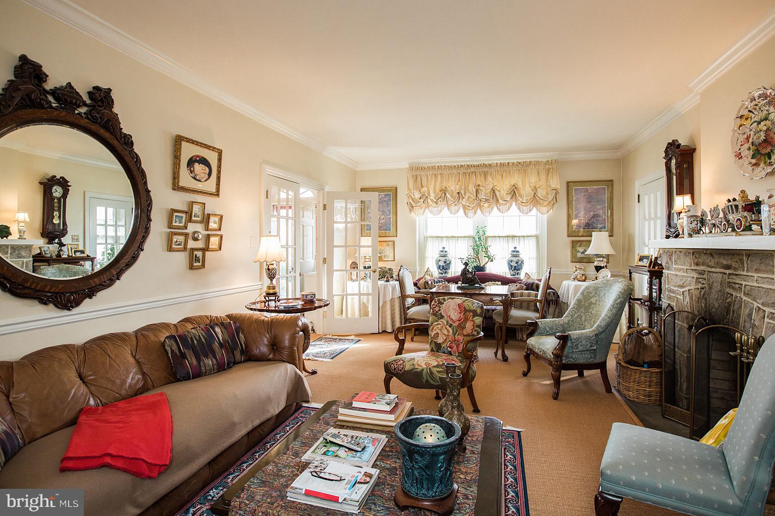 41 Hess Boulevard Lancaster, PA 17601 - Photo 31 of 63 a living room with furniture a fireplace and a large mirror next to a window