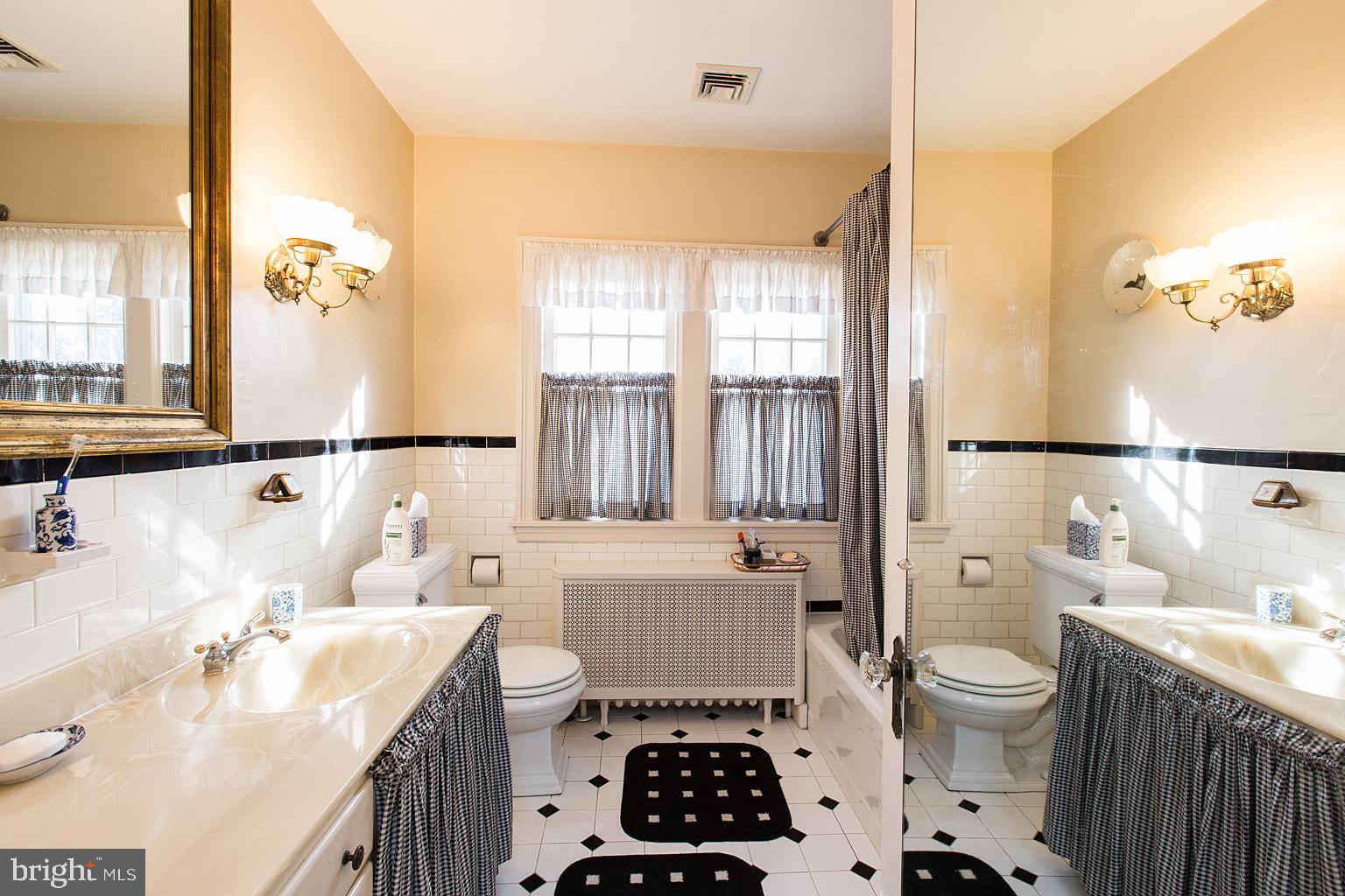 41 Hess Boulevard Lancaster, PA 17601 - Photo 43 of 63 a bathroom with a sink a toilet and a large mirror