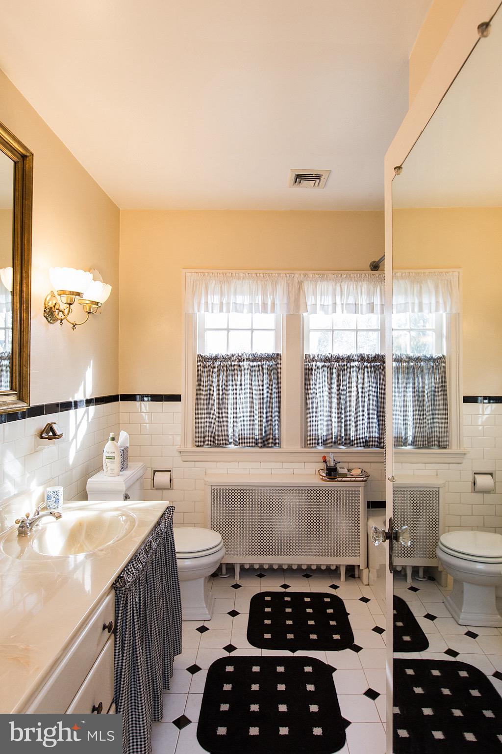 41 Hess Boulevard Lancaster, PA 17601 - Photo 44 of 63 a kitchen with a sink a stove a window and white wooden cabinets