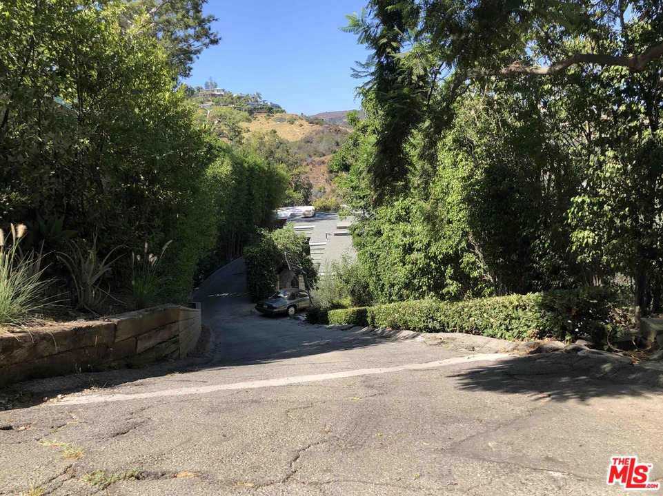 960 North Tigertail Road Los Angeles, CA 90049 - Photo 11 of 13 a view of a street with a yard and large trees